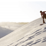 Sandboarding on sand dunes